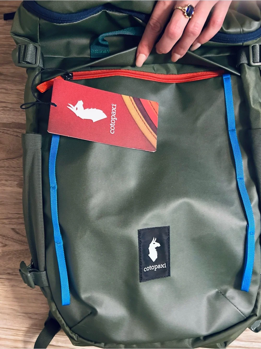 cotopaxi Olive Green Backpack with Blue and Teal Accents
